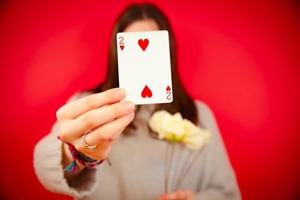 free-photo-of-woman-holding-a-two-of-hearts-card.jpg